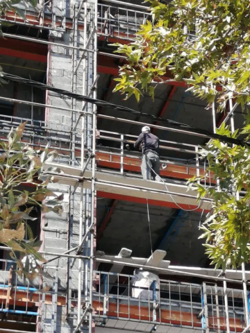 کارگران در حال نصب ناودانی منطقع و وال پست